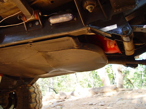 1996 Ford Bronco - The underside of a vehicle shows its fuel tank and suspension system.