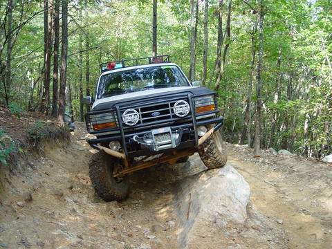 1996 Ford Bronco - This 1996 Ford Bronco navigates a challenging off-road course through a forest.