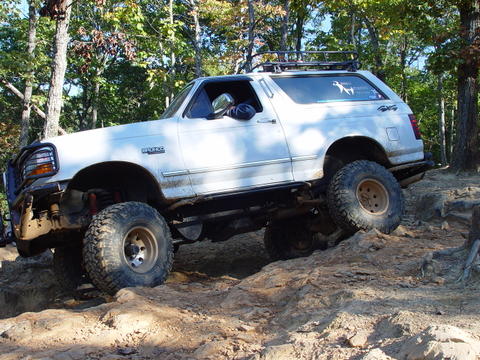 1996 Ford Bronco - This SUV is navigating a rocky trail, its off-road capabilities.