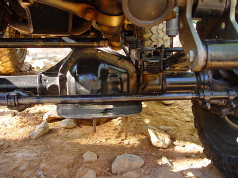 1996 Ford Bronco - The undercarriage of a vehicle is shown, with focus on the drivetrain and suspension components.