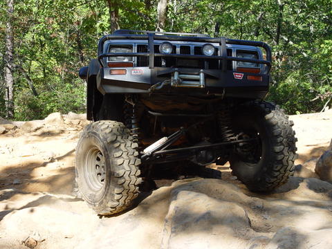 1996 Ford Bronco - This modified SUV is navigating a rocky trail, its off-road capabilities.