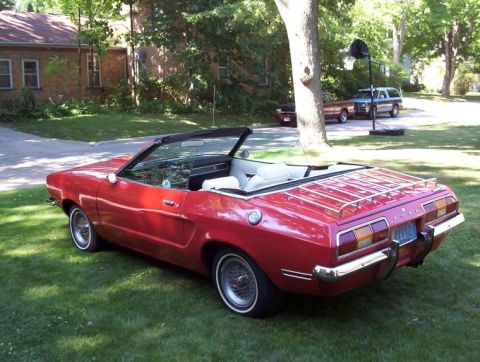 1978 Ford Mustang II - This 1978 Ford Mustang II convertible features a rear luggage rack and a visible license plate.