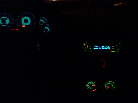 1997 Ford Probe - The glowing dashboard and radio display of a car at night.