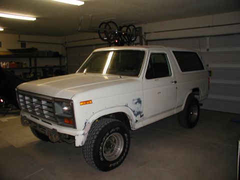 1986 Ford Bronco - This white SUV has a distinct boxy body style and appears to be from the early 1980s.