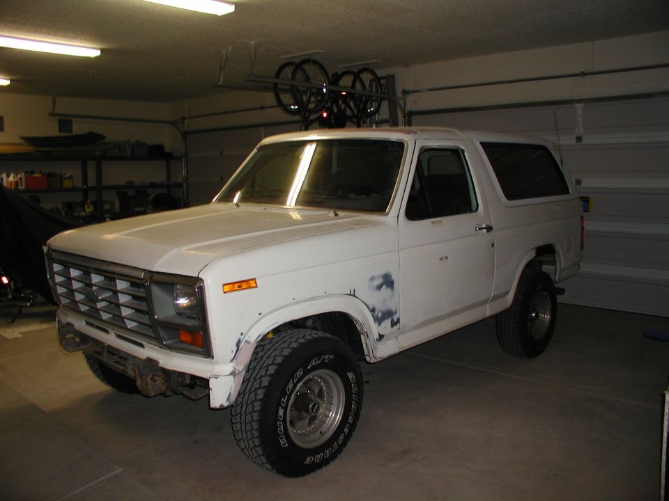 White SUV with a boxy body style and large tires, viewed from the front-right