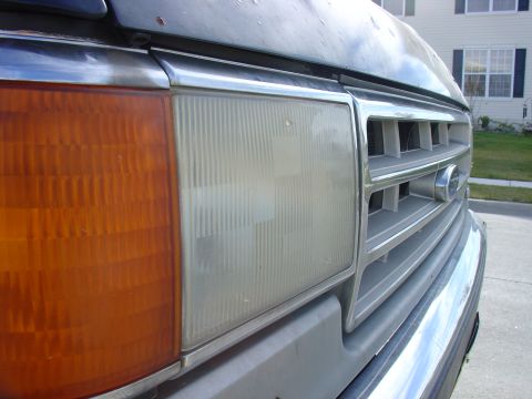 1988 Ford Bronco - Close-up of the front corner of a 1988 Ford Bronco, highlighting the grille and headlight assembly of the headlight assembly.