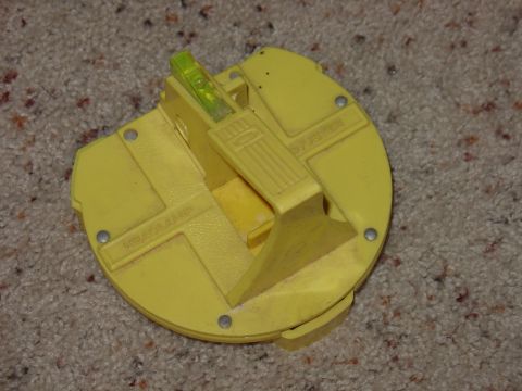 1988 Ford Bronco - This yellow plastic part has a bubble level and text indicating it is related to a headlamp.