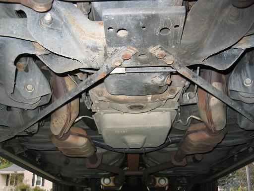 Underbody view of a 1999 Ford Crown Victoria showing the transmission, catalytic converters, and exhaust system