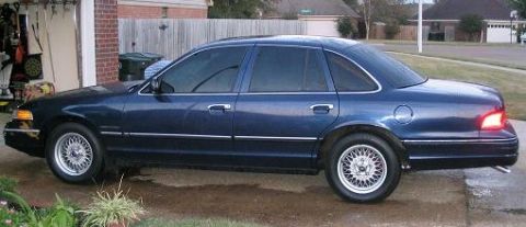 1994 Ford Crown Victoria - Side profile of a 1994 Ford Crown Victoria sedan, parked outdoors.