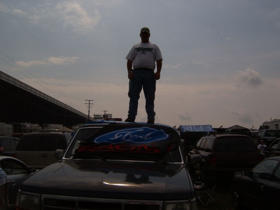 Dark SUV with Ford Racing banner on hood