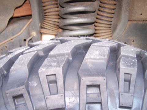 1991 Ford Bronco - Off-road tire and suspension components are shown in this close-up view.