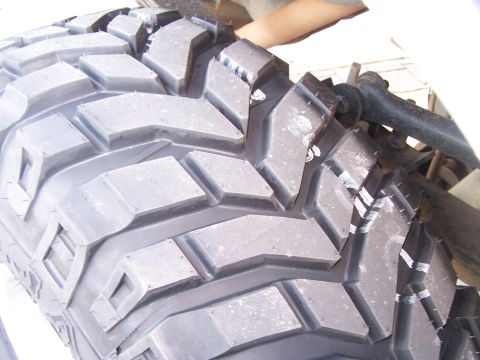 1991 Ford Bronco - A detailed view of an aggressive tire tread pattern, likely for off-road use.