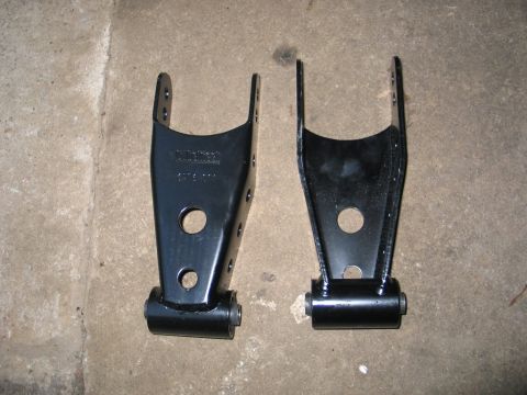 2004 Ford F-150 - Two black metal suspension drop shackles with rubber bushings are shown, one on the left has visible part numbers.