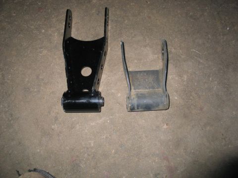 2004 Ford F-150 - Comparison of two leaf spring shackles, one appears to be an aftermarket part.