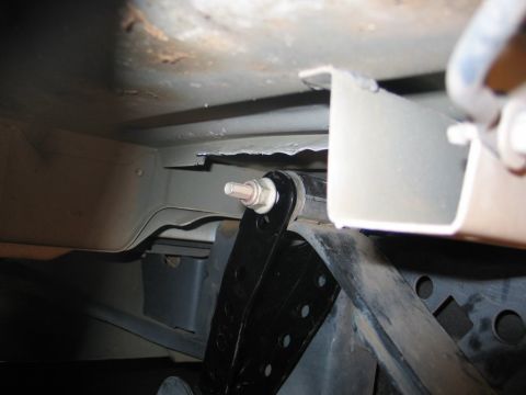 2004 Ford F-150 - Close-up view of a black drop shackle installation on the underbody of a vehicle.
