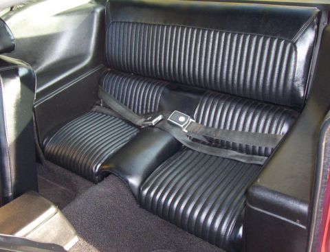 1969 Ford Mustang - The ribbed black vinyl rear seats and carpeting are visible in this car's interior.