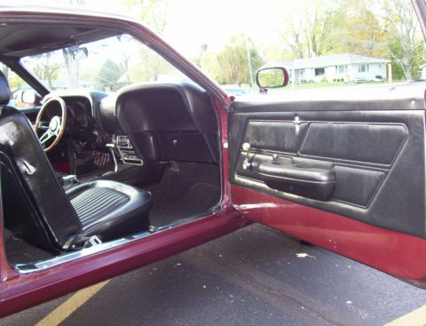 1969 Ford Mustang - Interior view of a 1969 Ford Mustang, highlighting the driver's side seat and door panel.