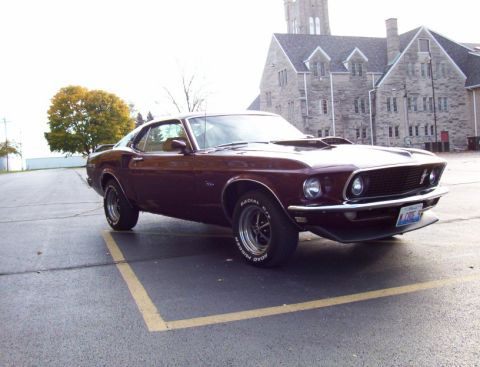 1969 Ford Mustang - This 1969 Ford Mustang is parked in front of a large stone building.
