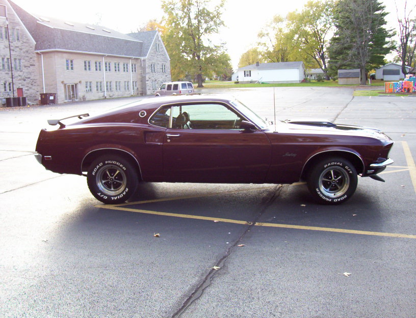 Maroon 1969 Ford Mustang fastback, side view