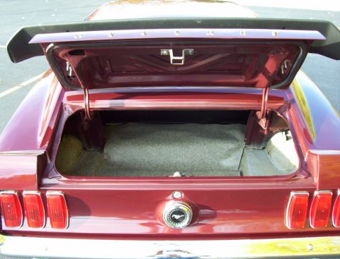 1969 Ford Mustang - Rear view of a 1969 Ford Mustang with the trunk open, revealing the cargo area.