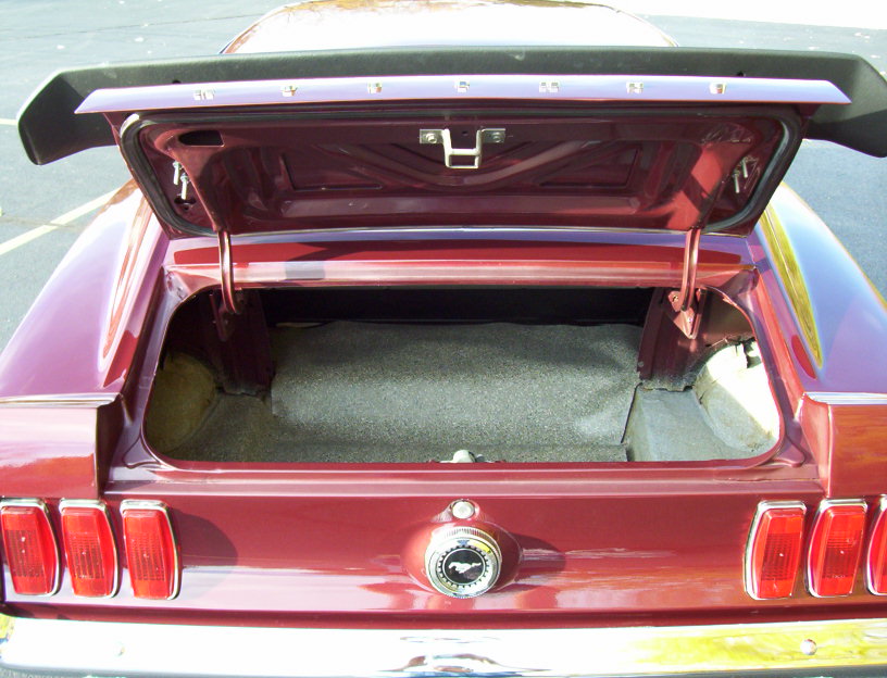 1969 Ford Mustang trunk open, showing carpeted interior and spoiler