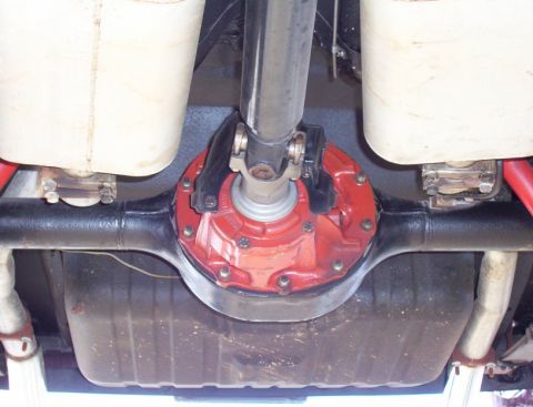 1969 Ford Mustang - The undercarriage of a 1969 Ford Mustang features a red-painted rear differential and dual exhaust system.
