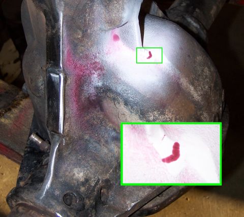 1979 Ford Bronco - Dye penetrant testing reveals cracks in the metal housing, indicated by red dye seepage.