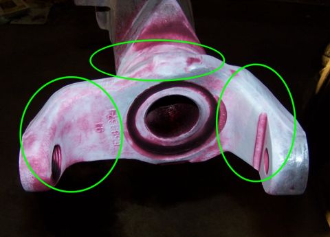 1979 Ford Bronco - A metal component, possibly a suspension part, shows red dye markings and is circled in green. Part number F-883574 is visible.
