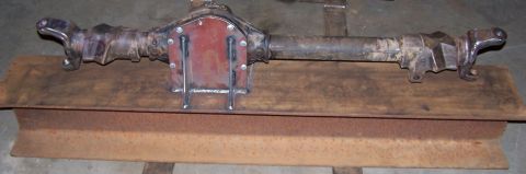 1979 Ford Bronco - A rear axle assembly, possibly from a Ford Bronco, is shown with a custom red cover plate welded onto the differential housing.