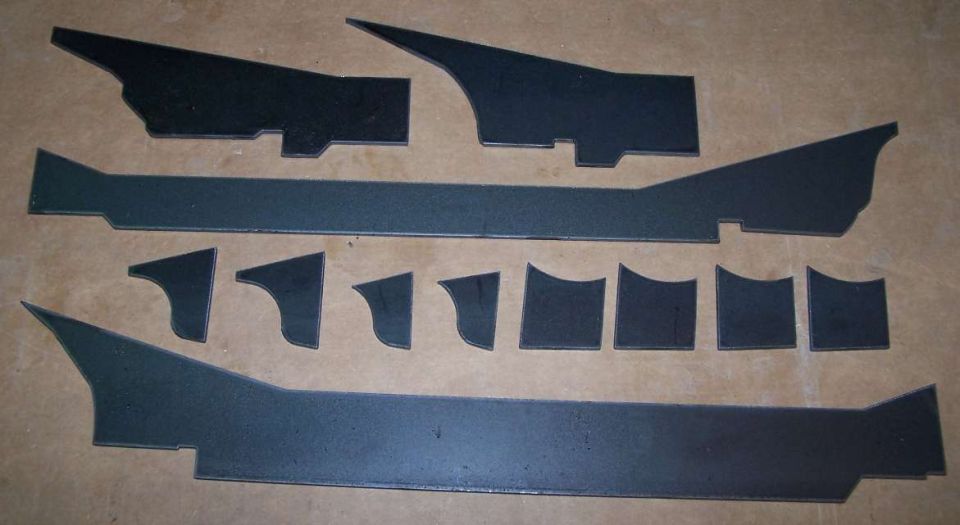 Collection of cut metal pieces laid out on a flat surface