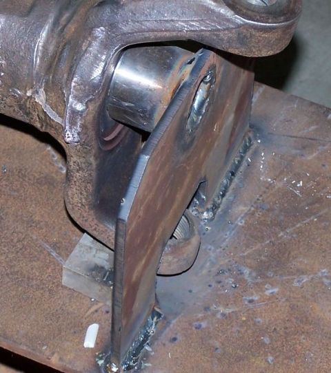 1979 Ford Bronco - Close-up of a custom metal bracket welded to a U-joint yoke, showing fabrication work.