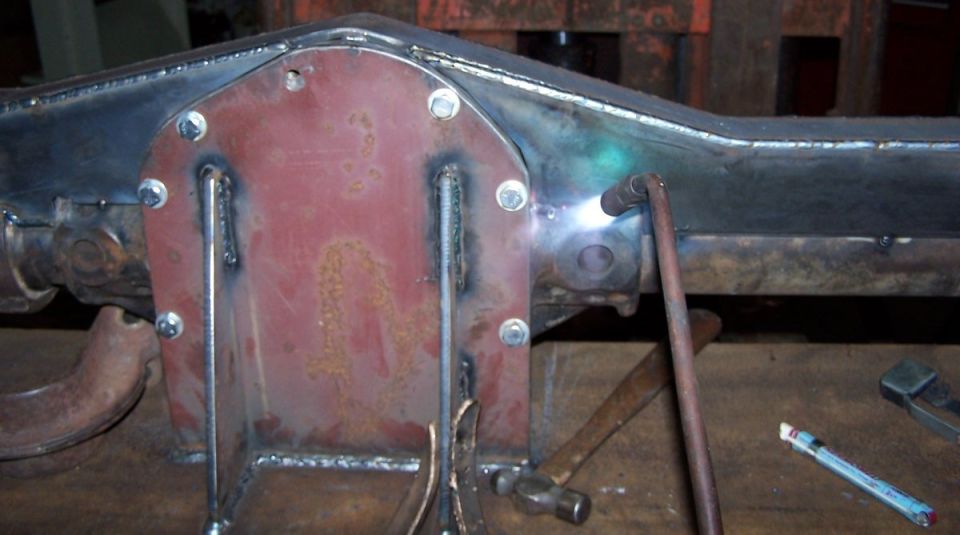 Welding a red differential cover onto a metal axle housing