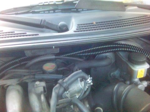 1994 Ford Probe - Close-up view of a vehicle's engine bay, showing various components and wiring.