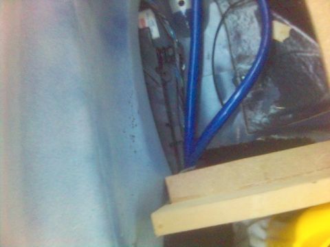 1994 Ford Probe - Close-up view of interior car components, including a blue metal bar and wooden blocks.