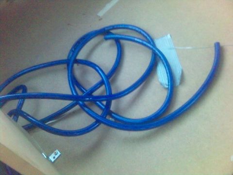 1994 Ford Probe - Blue tubing is coiled and secured with white tape.