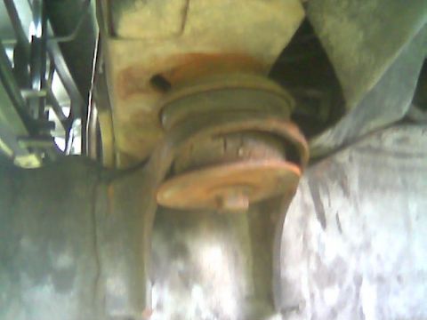 1992 Ford Bronco - Underside view of a vehicle's suspension bushing, showing signs of wear and tear.