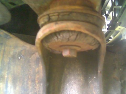 1992 Ford Bronco - Close-up of a worn suspension bushing with visible cracks.
