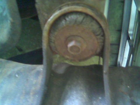 1992 Ford Bronco - A close-up view of a worn suspension bushing, showing signs of rust and damage.