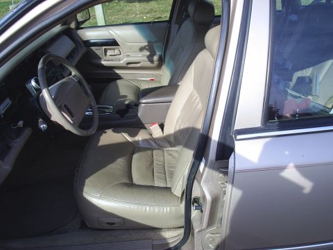 1993 Ford Crown Victoria - Interior view of a tan sedan, highlighting the driver's seat and dashboard details.