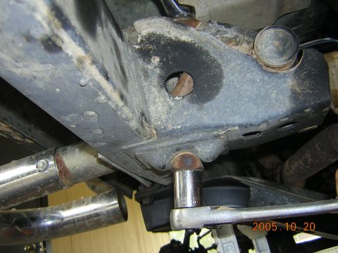 1992 Toyota Hilux - Close-up view of a vehicle's undercarriage, focusing on suspension work with a socket wrench.