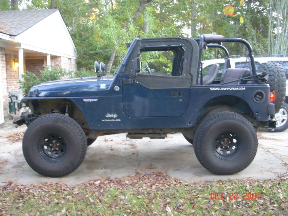Blue Jeep Wrangler, side view, lifted on black steel wheels with soft top removed
