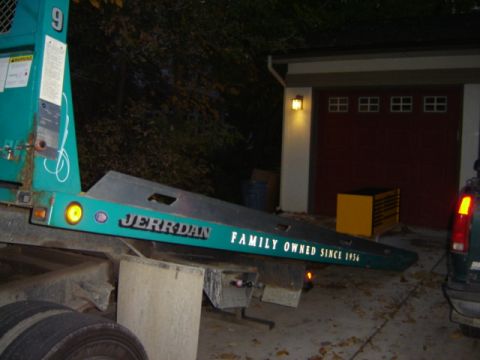 1992 Ford Bronco - The Jerr-Dan tow truck bed is visible, along with text indicating it's family owned since 1956.