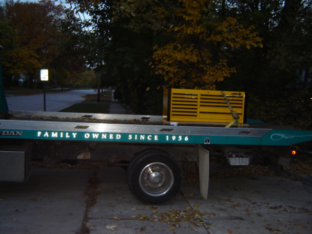 Tow truck bed with yellow toolbox and "FAMILY OWNED SINCE 1956" text