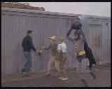 1996 Ford Bronco - Batman and his henchmen are in a standoff in front of a building.