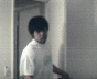 1989 Ford Bronco - A person wearing a white t-shirt stands in a doorway, looking towards the camera.