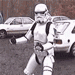 1989 Ford Bronco - A person in a Stormtrooper costume stands in front of two parked vehicles.