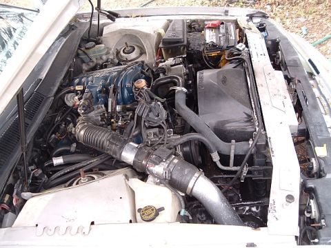 1992 Ford Thunderbird - The engine bay of a vehicle, showing the V6 engine and associated components.
