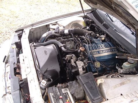 1992 Ford Thunderbird - The engine bay of a 1992 Ford Thunderbird is visible, with the 3.8L Fuel Injected V6 engine prominently displayed.