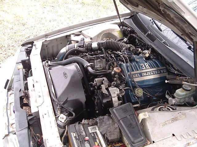 Engine bay of a 1992 Ford Thunderbird, showing the 3.8L Fuel Injected V6 engine, radiator, and battery