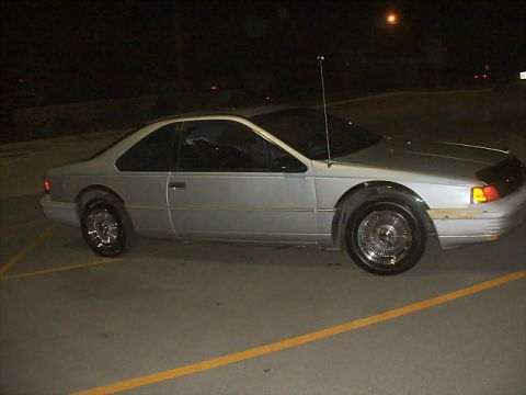 1992 Ford Thunderbird - Side view of a silver 1992 Ford Thunderbird coupe at night.